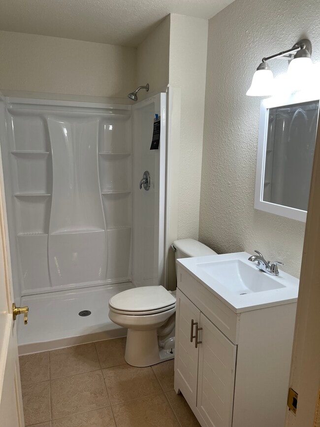 Bathroom remodeled with shower surround. - 217 N 1st St Unit 7
