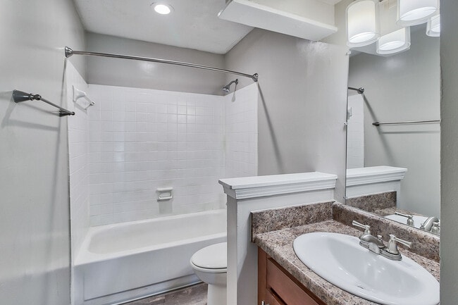 Bright bathroom with tile backsplash and bathtub