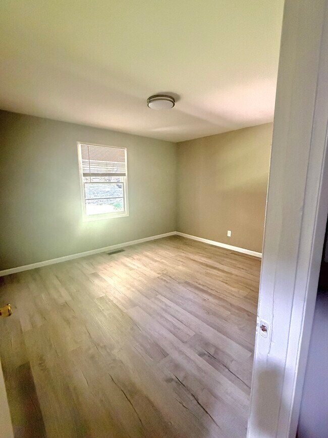 Bedroom 1 - natural light, updated flooring, and a neutral color palette. - 112 Live Oak Dr Unit 110