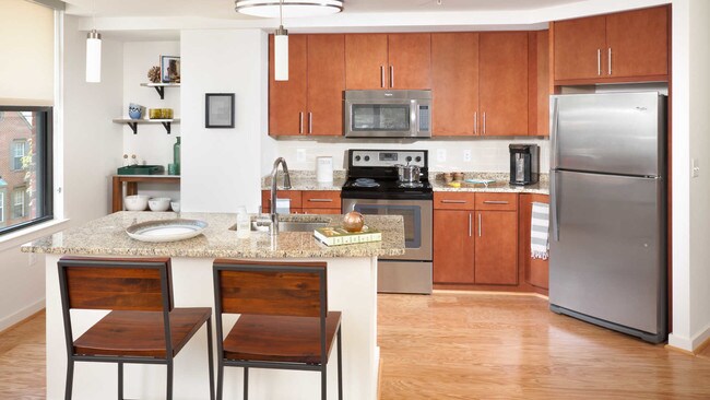 Island Kitchen with Stainless Steel Appliances, Cherrywood Cabinets and Hard Surface Flooring