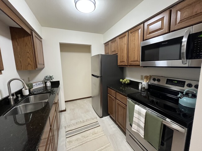 New York Kitchen with Amish Cabinetry and Granite Countertops - High Point Commons Apartments