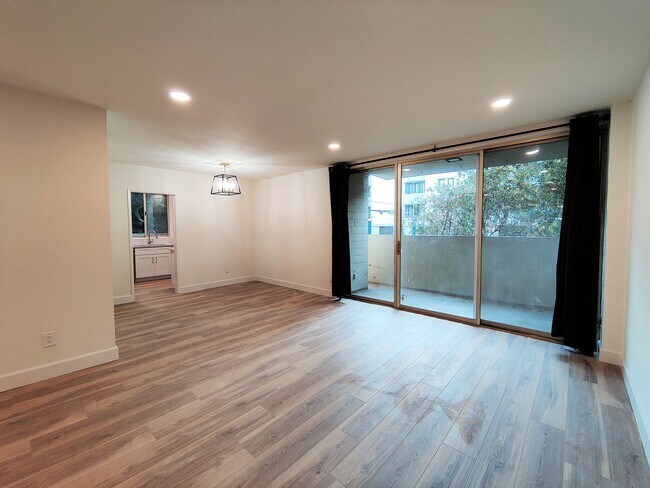 Living Room leading to Dining Area & Private Balcony - 1300 Midvale Ave Unit 211