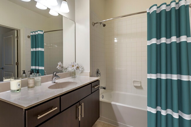 Newly renovated apartment homes feature baths with espresso cabinetry, grey quartz countertops, and hard surface flooring
