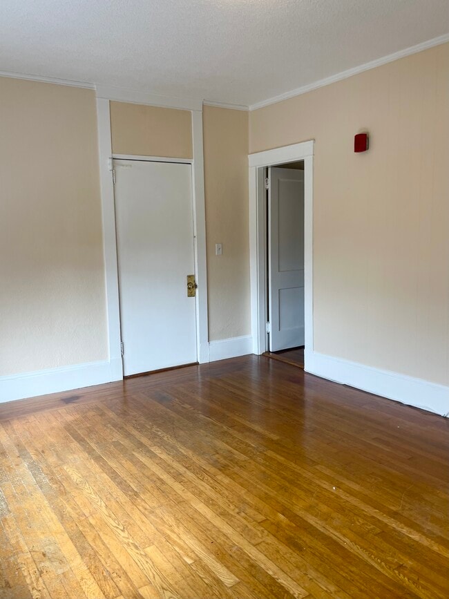 Living room with front entrance and kitchen to the right - 144 Van Zandt Ave Unit 9