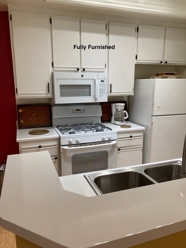 Bright white kitchen with new dishwasher and new microwave