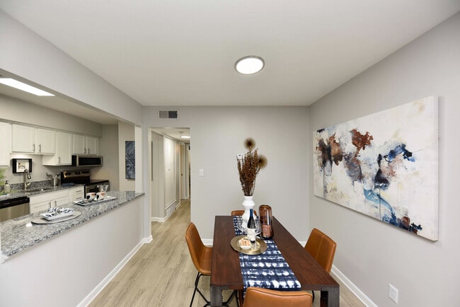 Dining area with hardwood-style flooring & built-in lighting - Nora