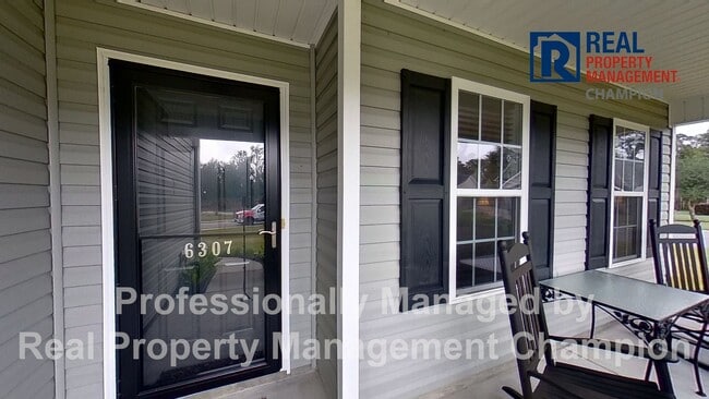 Photo - Beautiful home boasts open floorplan, screened porch, and spacious fenced yard