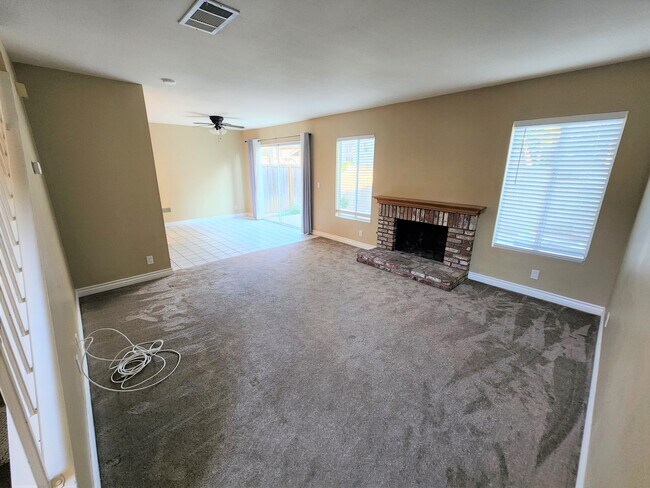 Living Room with Fireplace Opens to Dining Area - 630 W Palm Ave