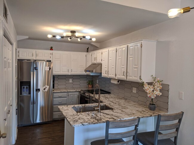 Kitchen updated with high end granite and stainless steel appliances - 14151 Montfort Dr Townhome