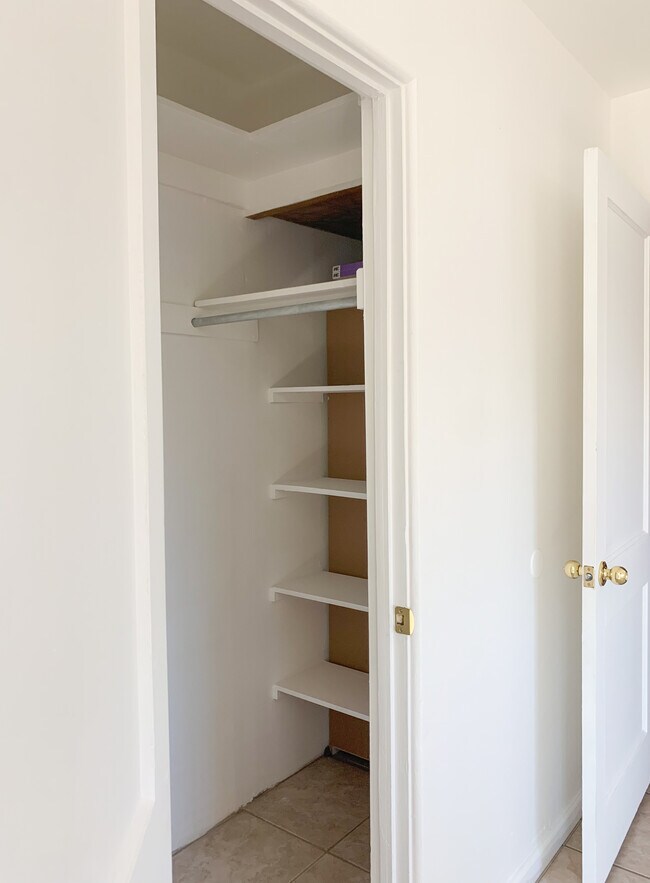 Master Bedroom Closet with two clothing racks, shelves and an upper shelf - 5551 N 12th Ave