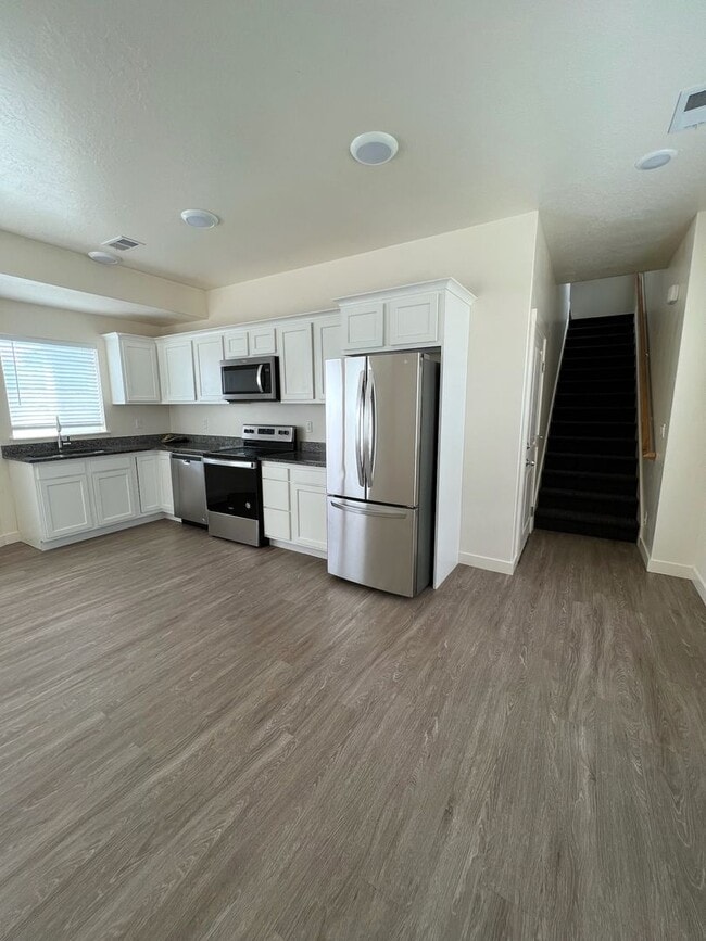 Photo - Hurry—Deposit Moves You In! | Modern 3-Bedroom Townhome with a 2-Car Garage & Private Balcony in ...