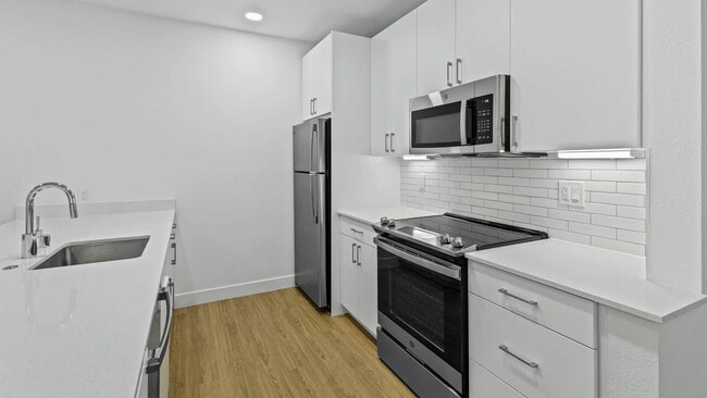 Kitchen with Stainless Steel Appliances - Park Place at San Mateo