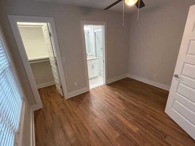 Private First-Floor Bedroom: Spacious suite with hardwood floors, private bath, and walk-in closet. - 421 Elysian Fields Rd Unit 5