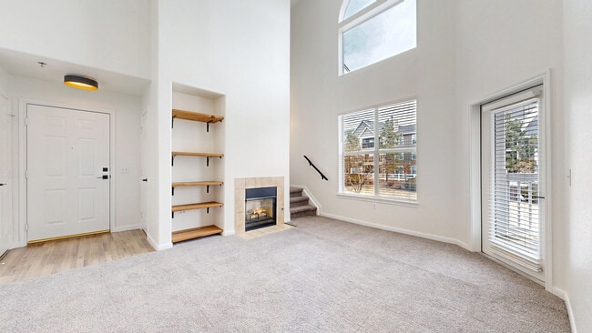 Living Room with fireplace, stairs to loft - 6021 Castlegate Dr W Unit E25
