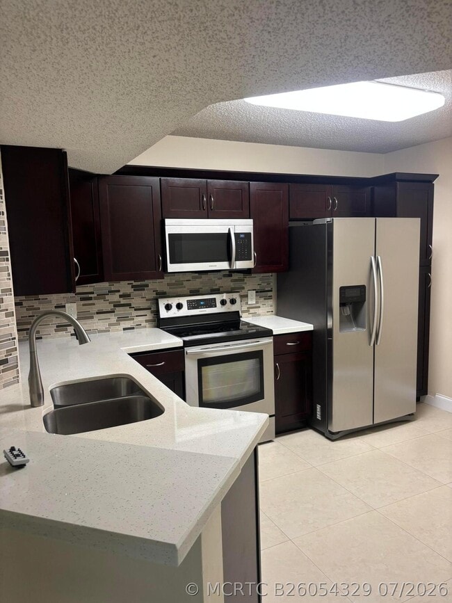 Building Photo - 8761 Wiles Rd Unit 304