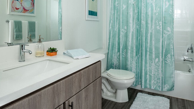 Apartment Bathroom with large soaking tub and hardwood flooring. - Griffis Pine Avenue