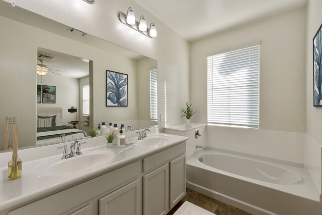 Dual sink vanity in master bathroom with soaking tub