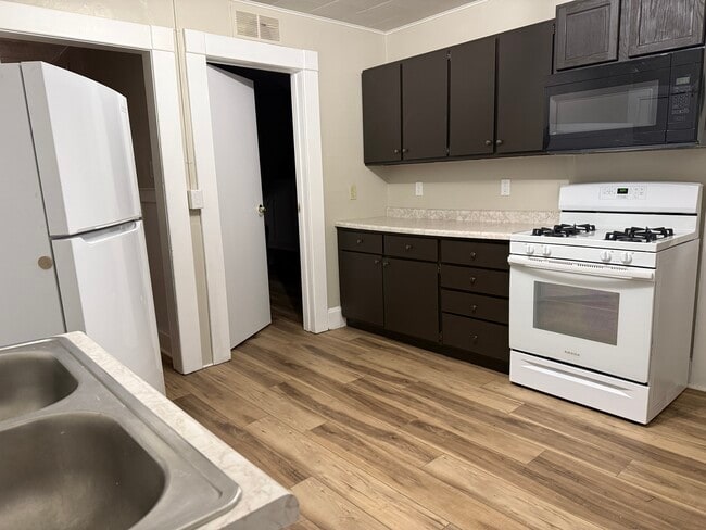 Updated kitchen with new gas stove and overhead Microwave - 377 Ellis St Unit 377 Duplex Upper