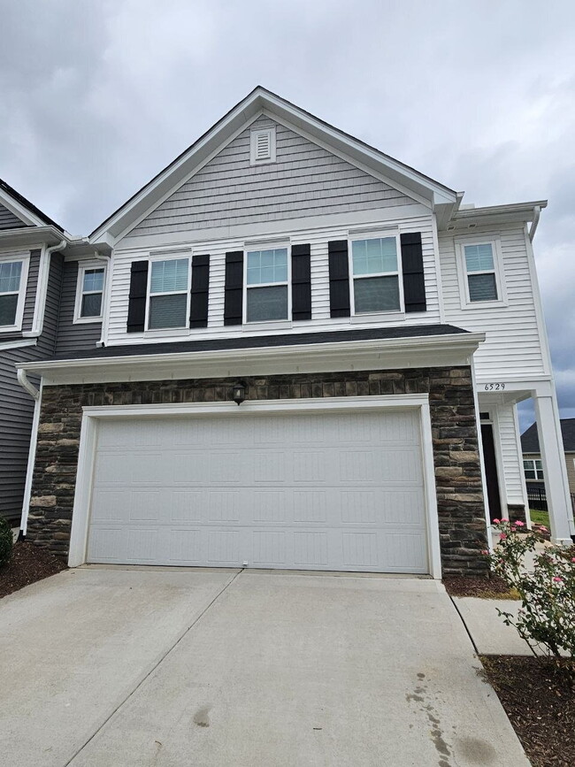 Modern townhome with high-end finishes throughout, minutes to 540 and walkable to great shopping.