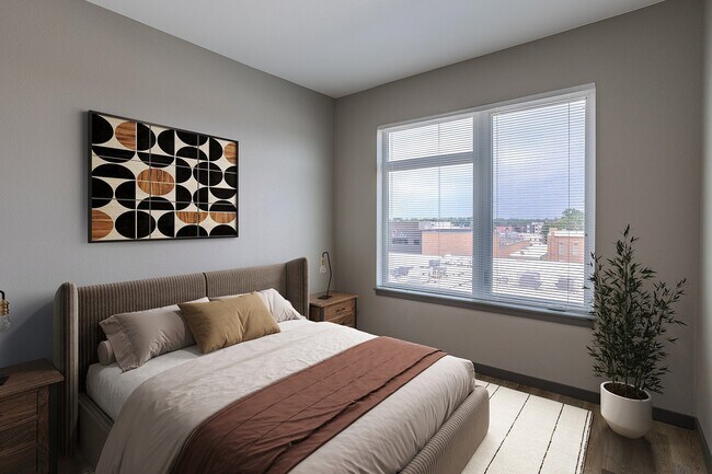 Dormitorio espacioso con luz natural. - Patina Flats at the Foundry Apartments