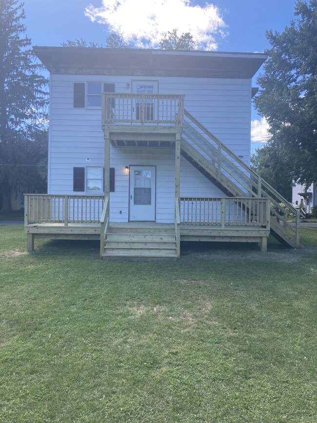 Back of house with stairway leading to second floor apartment. - 12 Baker St Apartments Unit Second Floor