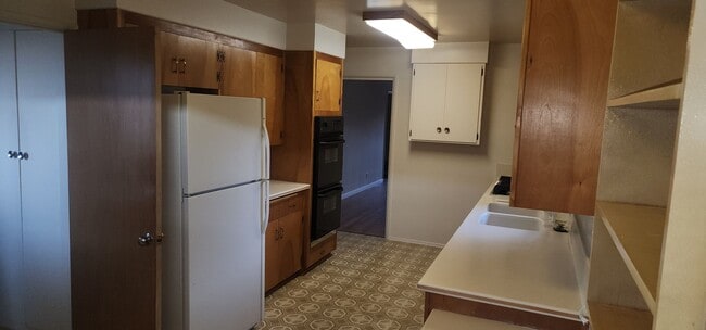 Photo - This is a spacious house featuring four bedrooms and two bathrooms, along with a two-car garage.