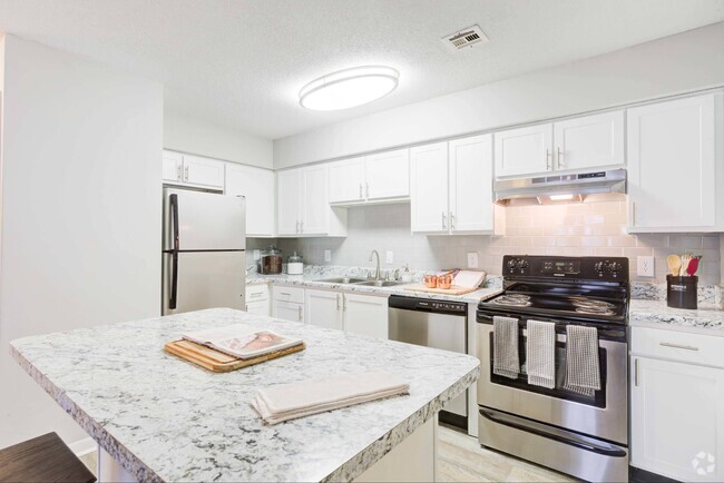 Kitchen with white cabinetry and stainless steel appliances - Avana Collins Creek Rental