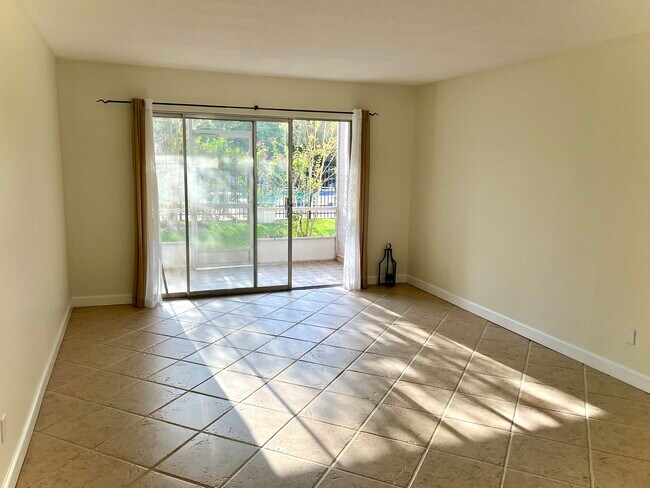Living room looking toward porch and pool - 1250 S Denning Dr Condo Unit Mead Gardens