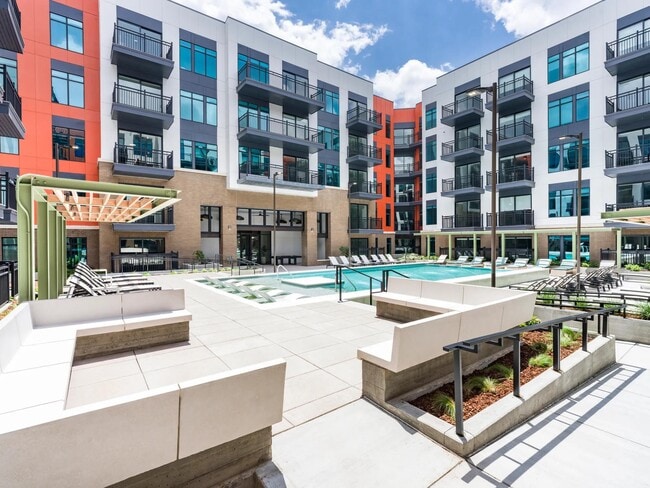 A fresh perspective on downtown leisure — unwind in the expansive pool courtyard, designed for comfort, connection, and a splash of sun.