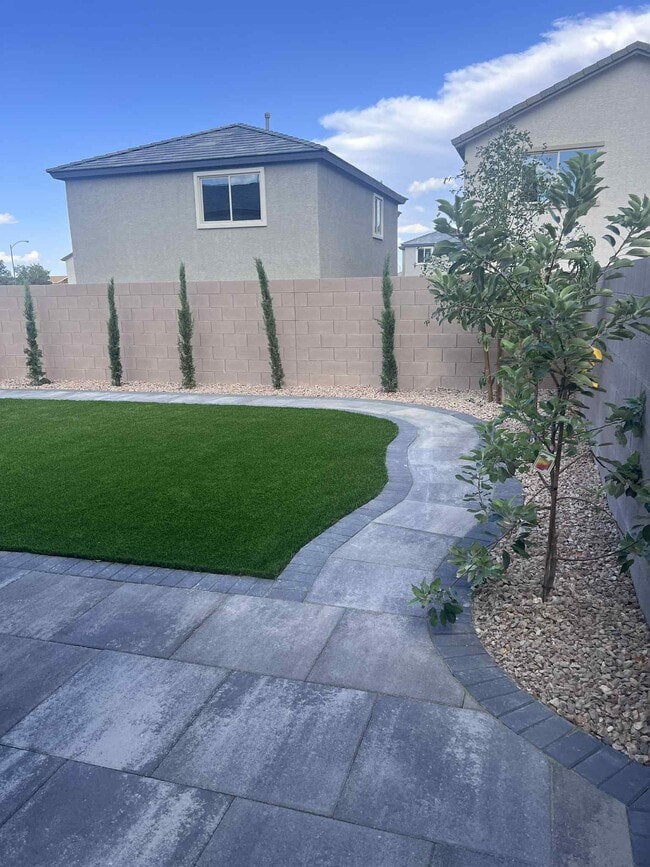 land scaped backyard with walk around paver path - 5924 Tomsik St