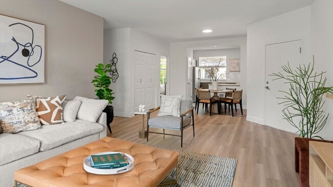Bright living spaces feature private balconies, large windows, and contemporary finishes