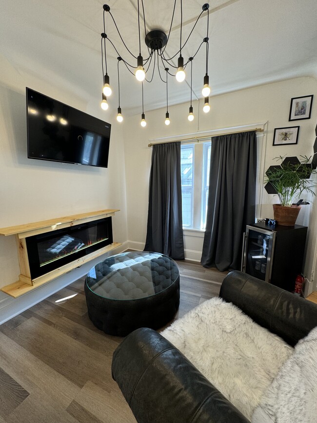 Living room/ electric fireplace / wine cooler - 4315 Fairmount Ave Apartments Unit 1 Charming