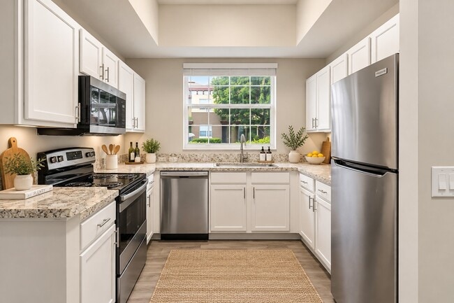 Embrace modern living at Delray Bay with a spacious and stylish kitchen featuring sleek appliances and beautiful countertops. Perfect for culinary adventures or casual dining. See how this space can elevate your lifestyle—schedule a tour today!