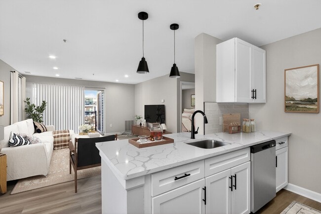 Step into modern luxury at Eagle Rock Apartments at Columbia Pike. This beautifully designed kitchen features sleek finishes and ample space for entertaining. Don't miss your chance to call this home. Schedule a tour today! - Eagle Rock Apartments at Columbia Pike