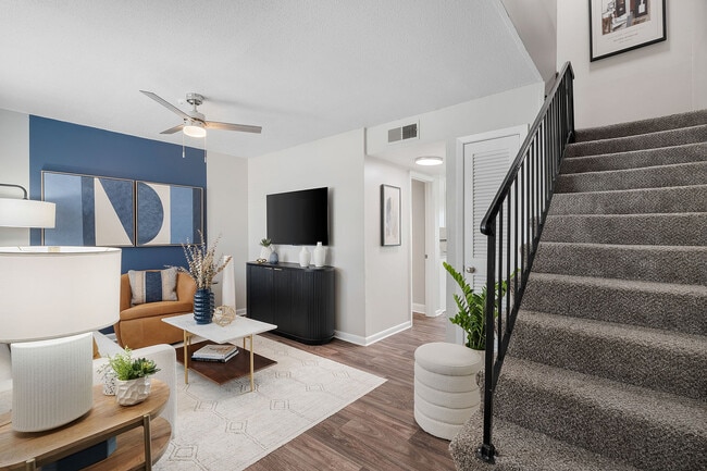 Living room with hardwood-style flooring & ceiling fan