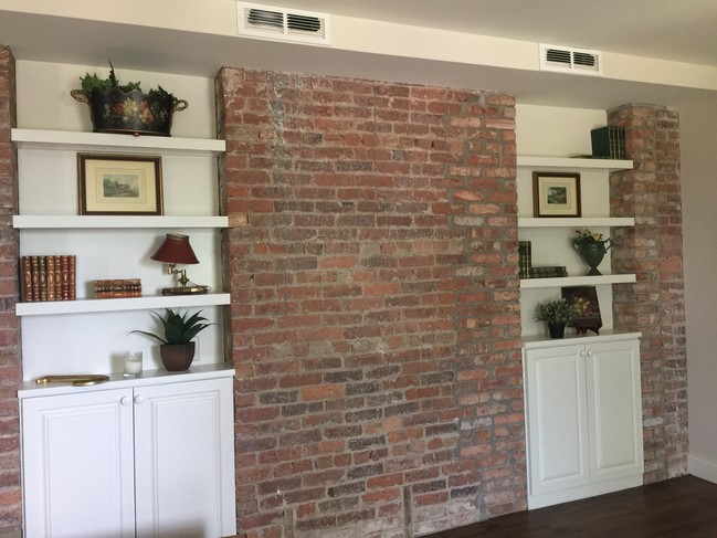 Bookcases in living room extra storage - 100 W 10th St Apartments