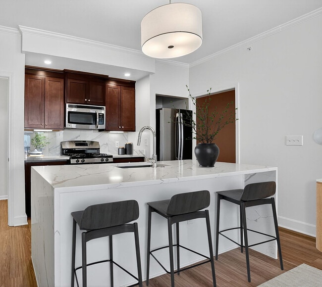 Elegant Kitchen | Waterfall Quartz Countertops & Gas Stove