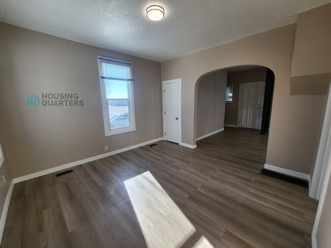 Photo - This 3-bed, 1-bath home features original woodwork, a covered front porch, a fenced yard, and an ...