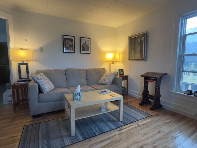 Looking towards the corner of the living/dinning room from the street side. - 25 Monroe St Unit 1