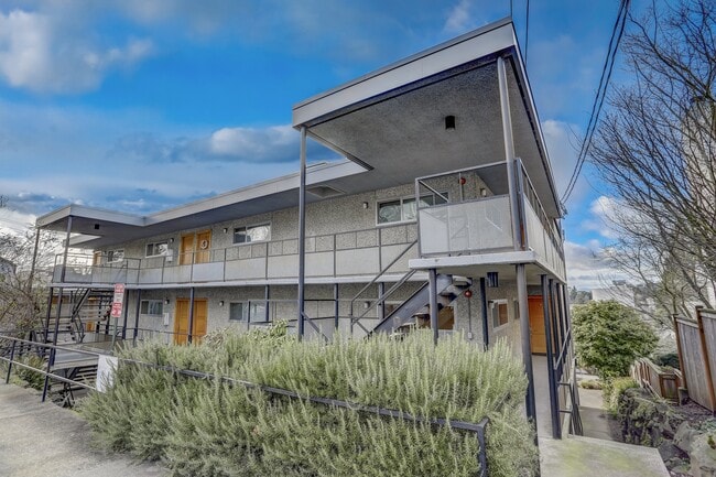 An exterior view of the building highlighting its architectural details and well-maintained landscaping, creating an inviting and aesthetically pleasing environment. - Alaska 45