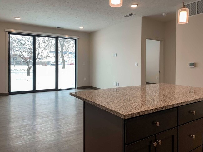 Relaxation meets culinary creativity, where the heart of the home basks in the glow of expansive windows and open space.
