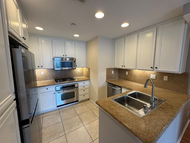 Photo - Sleek 2-Bed with a Den/Office + Flex Corner Condo with Attached Tandem Garage