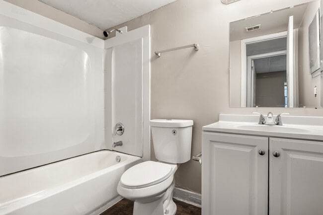 Bright and inviting bathroom with a modern bathtub, sleek vanity, and elegant fixtures. - Alderman Park Apartments