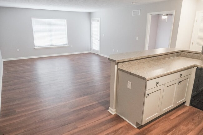 The view from the kitchen to the living room and access to the patio - Willow Green Apartments