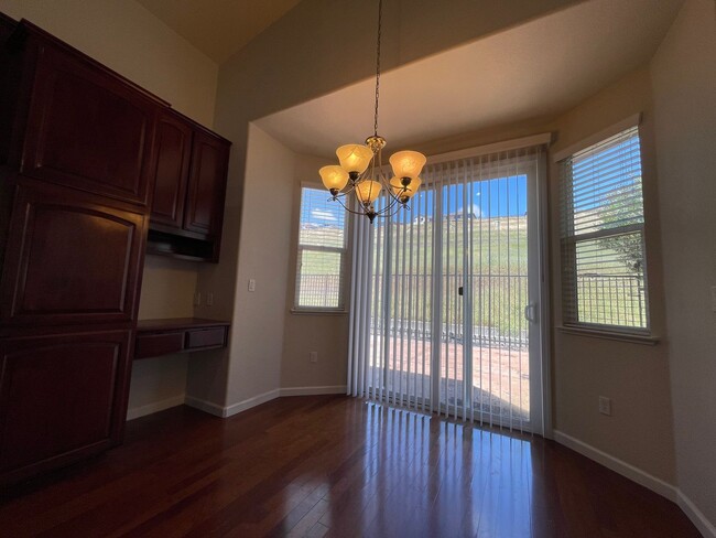 Photo - Fireplace in Living Room, Backyard Patio, Hardwood and Laminate Flooring