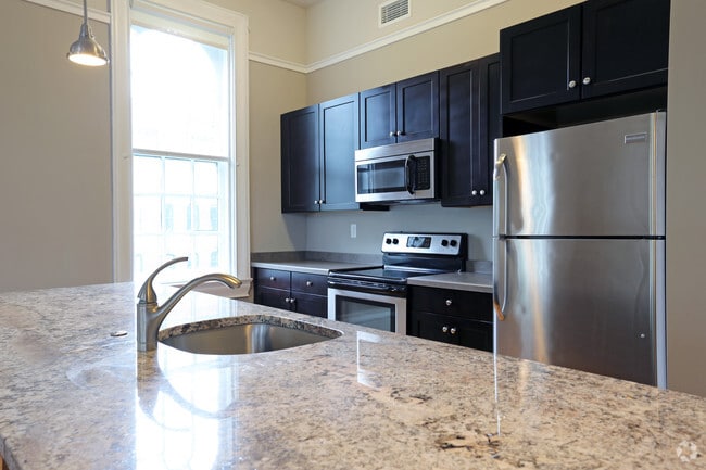View of Typical Kitchen Island with Granite Top & Stainless Steel Appliances