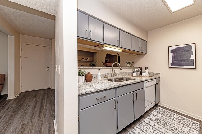 Kitchen with granite counters and hardwood-style flooring