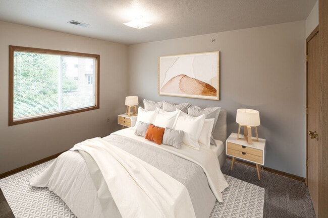 Highland Meadows Apartments in Bellevue, NE Comfortable Bedroom with Large Window and Plush Bed