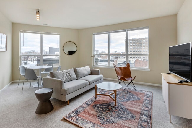 Furnished+ apartment homes come outfitted with a sofa, side chair, side table, coffee table, TV stand and 50" Television (Representative Image – exact items and style of furnishings may vary)