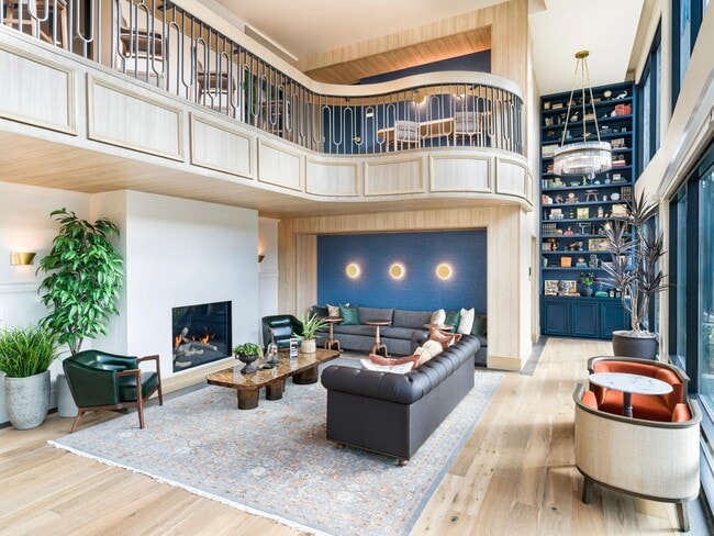 Expansive clubroom with fireplace and lounge seating at Modera University Park.